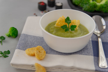 Cream of broccoli soup. Decorated with parsley and crackers. Healthy, tasty, vegetarian food for gourmets. Scandinavian style.