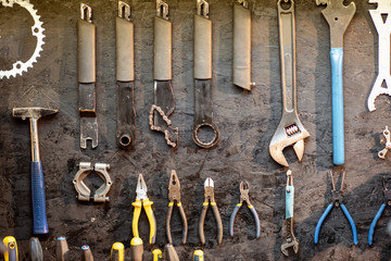 Wall with different working tools and wrenches for bicycle repairing
