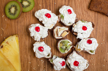 Sweet rolls made of pancakes filled with fruit and covered with cream and jam. Sweet breakfast Delicious dessert