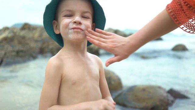 mom masks her son with sunblock cream