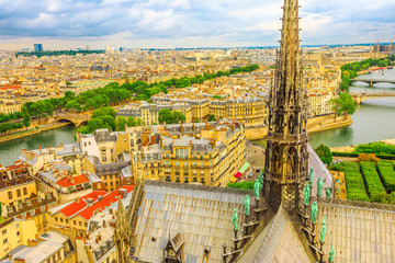 Close up aerial view on the spire of Notre Dame cathedral with statues, in Paris city capital of...