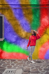 Smiling girl on the background of a colored wall