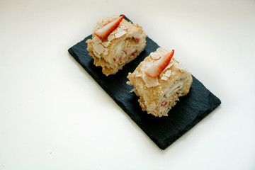 cake roll with strawberries isolated on white background
