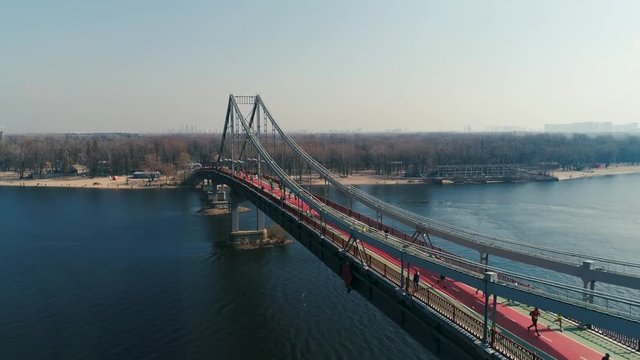 Marathon running on the footbridge. Dolly shot
