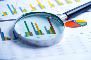 Magnifying glass on charts graphs spreadsheet paper. Financial development, Banking Account,...
