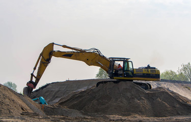 Fototapeta na wymiar Excavator loading sand in the truck