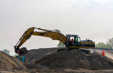 Excavator  loading sand in the truck