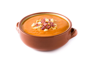 Typical Spanish salmorejo cream with ham and egg isolated on white background
