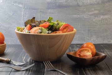 tomato and green oak lettuce salad on bowl
