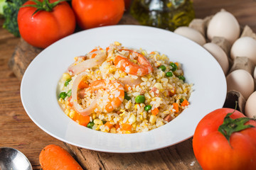 Seafood fried rice on wooden background，Thai Food ，Shrimp fried rice.