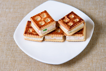 Cookies with marshmallows and marmalade on a white plate. Fresh homemade pastries.