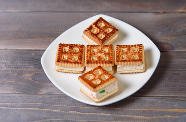 Cookies with marshmallows and marmalade on a white plate. Fresh homemade pastries.