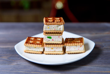 Cookies with marshmallows and marmalade on a white plate. Fresh homemade pastries.