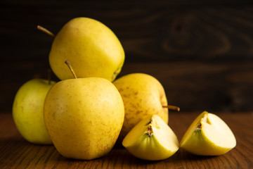 Yellow apple on the wooden vintage background