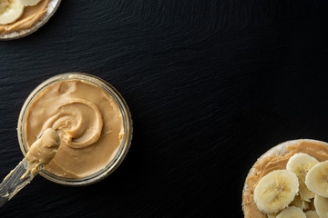 Peanut butter and banana on rice cakes, healthy, dietary food. Black background.