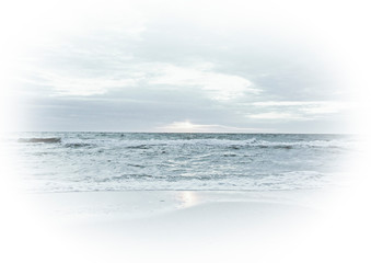 Obraz premium Light turquoise photo of the sea and sky with vignette. Background for tourism postcards and print design with waves by the shore and the beach. Sunset in the ocean.