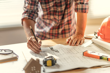 Architect & Engineer working drawing document about project planning and progress of work schedule on the home building construction site