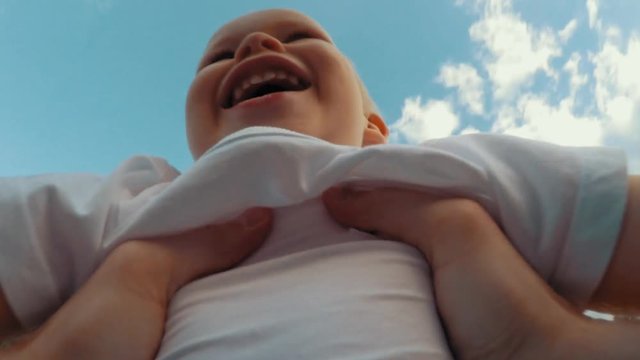 Father hands throw up little cute smiling son playing together POV shot