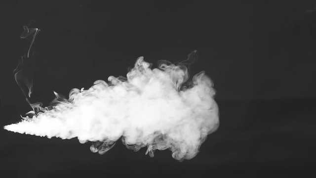 Smoke cloud. Smoke on black background in blue light, slow motion
