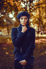 emotional portrait of Fashion stylish portrait of pretty young hipster blonde woman,going crazy,elegant black hat,soft colors,cool crazy  girl.Red urban wall background.surprised girl close up, sunset