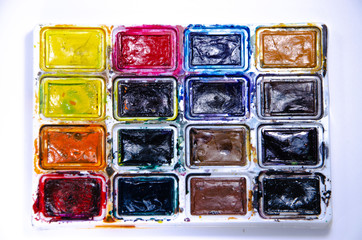 Palette with watercolors and brushes for paints on a white background. Watercolor paints. Brushes. Top and front view