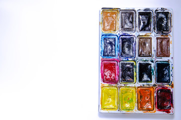Palette with watercolors and brushes for paints on a white background. Watercolor paints. Brushes. Top and front view