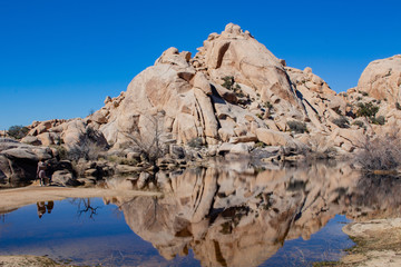 Mountain reflecting in pool of blue water