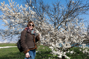 Woman smelling apple tree flower