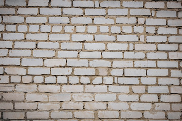 Wall is made from bricks and painted with white color.