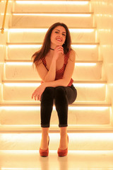 Girl on illuminated staircase