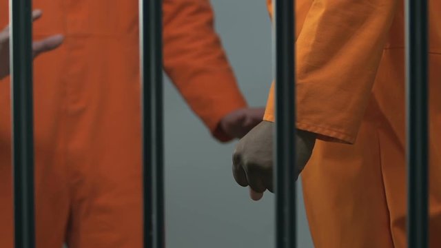 Aggressive multiracial prisoners fighting in jail, conflict between cellmates