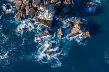 Blur of sea waves colors breaking in the coast of Lekeitio, Basque country - drone aerial view,...