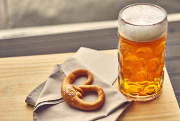 Sausages with potatoes and Pretzels Bavarian with a beer 