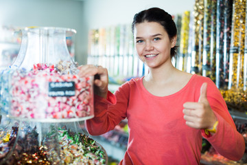  girl buying candies at shop