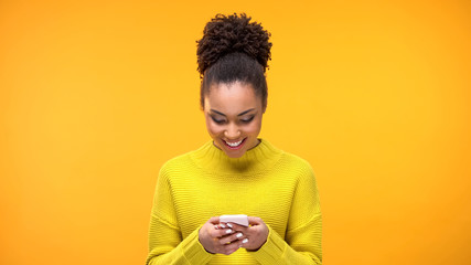 Smiling African-American woman chatting on smartphone, modern technology, app - obrazy, fototapety, plakaty