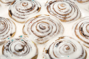Baked cinnamon buns were poured over with a white icing to soak