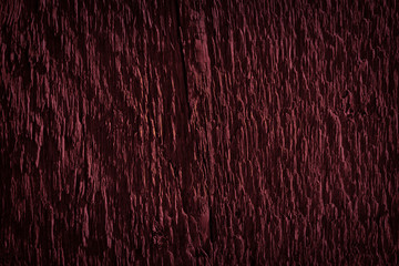 Texture of dark burgundy old rough wood. Mahogany abstract background for design. Vintage retro