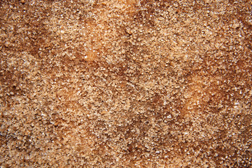 Sugar mixed with cinnamon scattered on the surface of the table