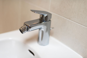Sanitary fittings for bathrooms, faucets, shower cubicles, water taps, ceramic tiles and mosaics.