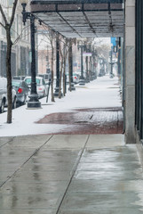 Snowy sidewalk on quiet street