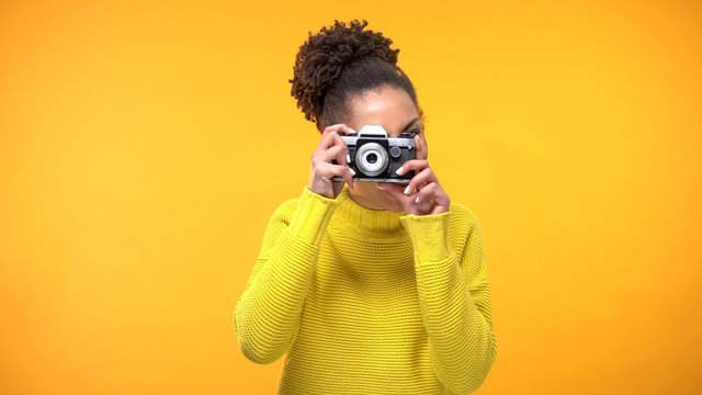 Young black woman making photo old-style camera, famous landmarks, sightseeing