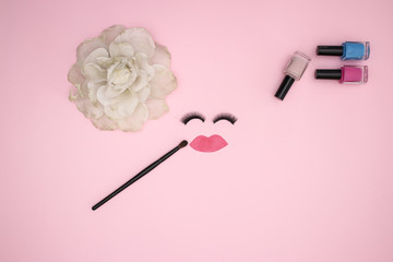 Make up and woman's accessories and eye lashes on the pink background 