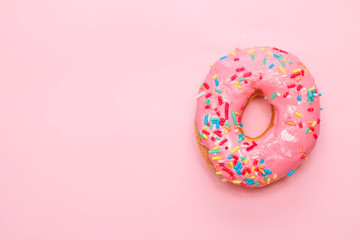 Fototapeta na wymiar Donut in a pink glaze on a gently pink background.