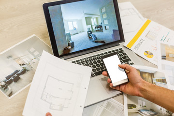Construction engineer and architect's desk with house projects, laptop, tools and wood swatches top...