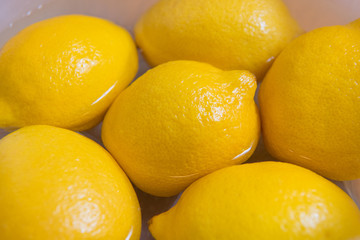 Fresh yellow lemons on a wooden background.. sweet lime, vitamin c.
