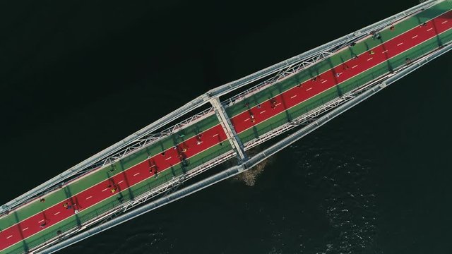 Marathon running on the footbridge. Spin top view shot