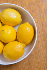 Fresh yellow lemons on a wooden background.. sweet lime, vitamin c.