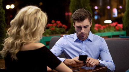 Businessman not paying attention to his girlfriend, addicted to gadget, problem
