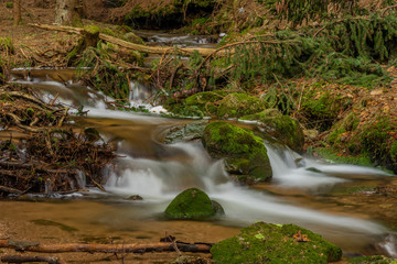 Big spring water on nice creek in spring day in Krusne mountains