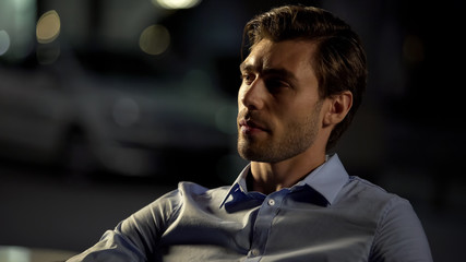 Obraz premium Pensive businessman sitting in cafe, tired after hard day, waiting for drinks